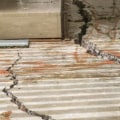 What are two of the most common cause of cracks in concrete slabs?